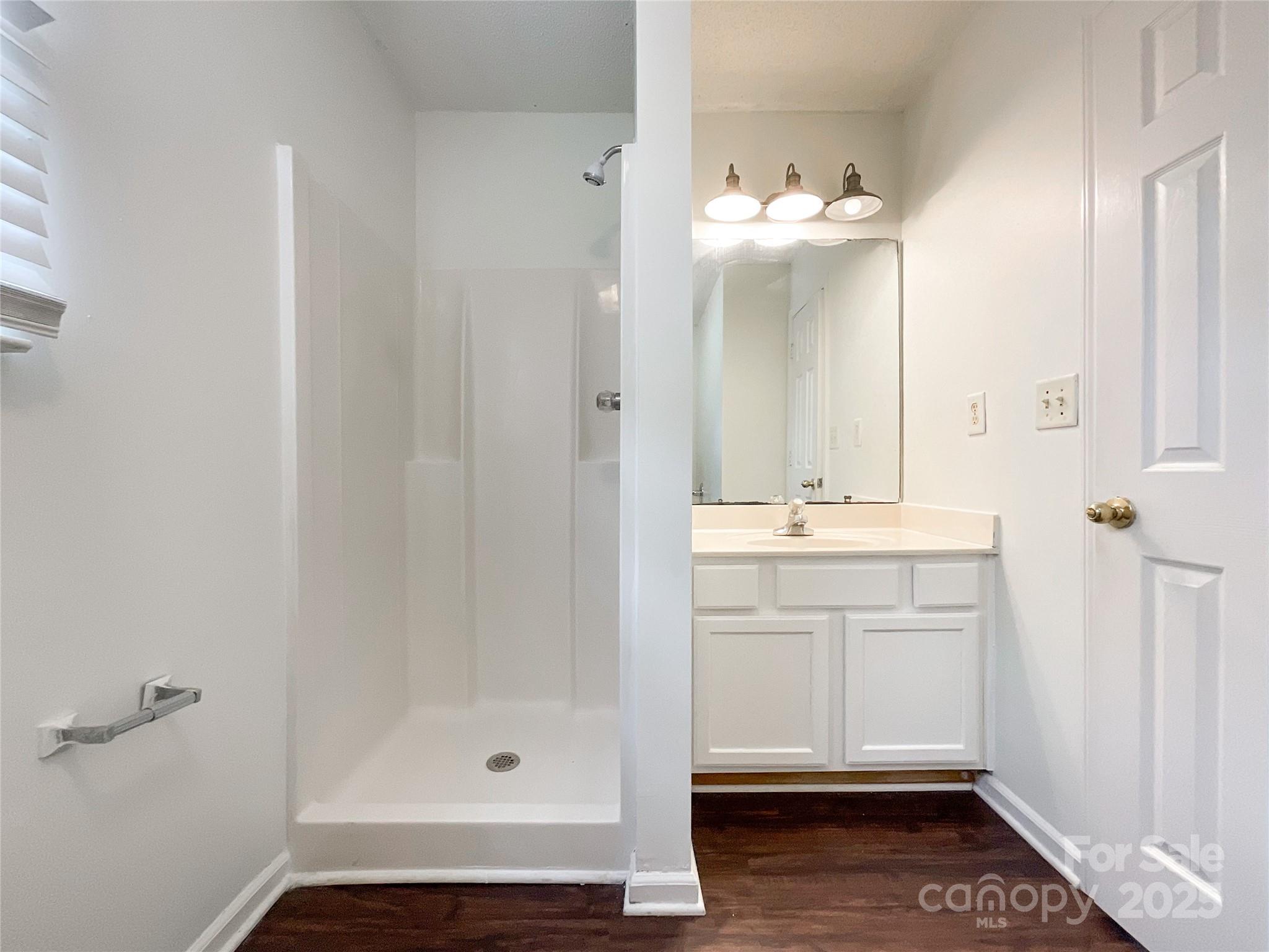 5610 Stone Bluff Court Charlotte, NC 28214 - Photo 28 of 41 a bathroom with a mirror and a sink