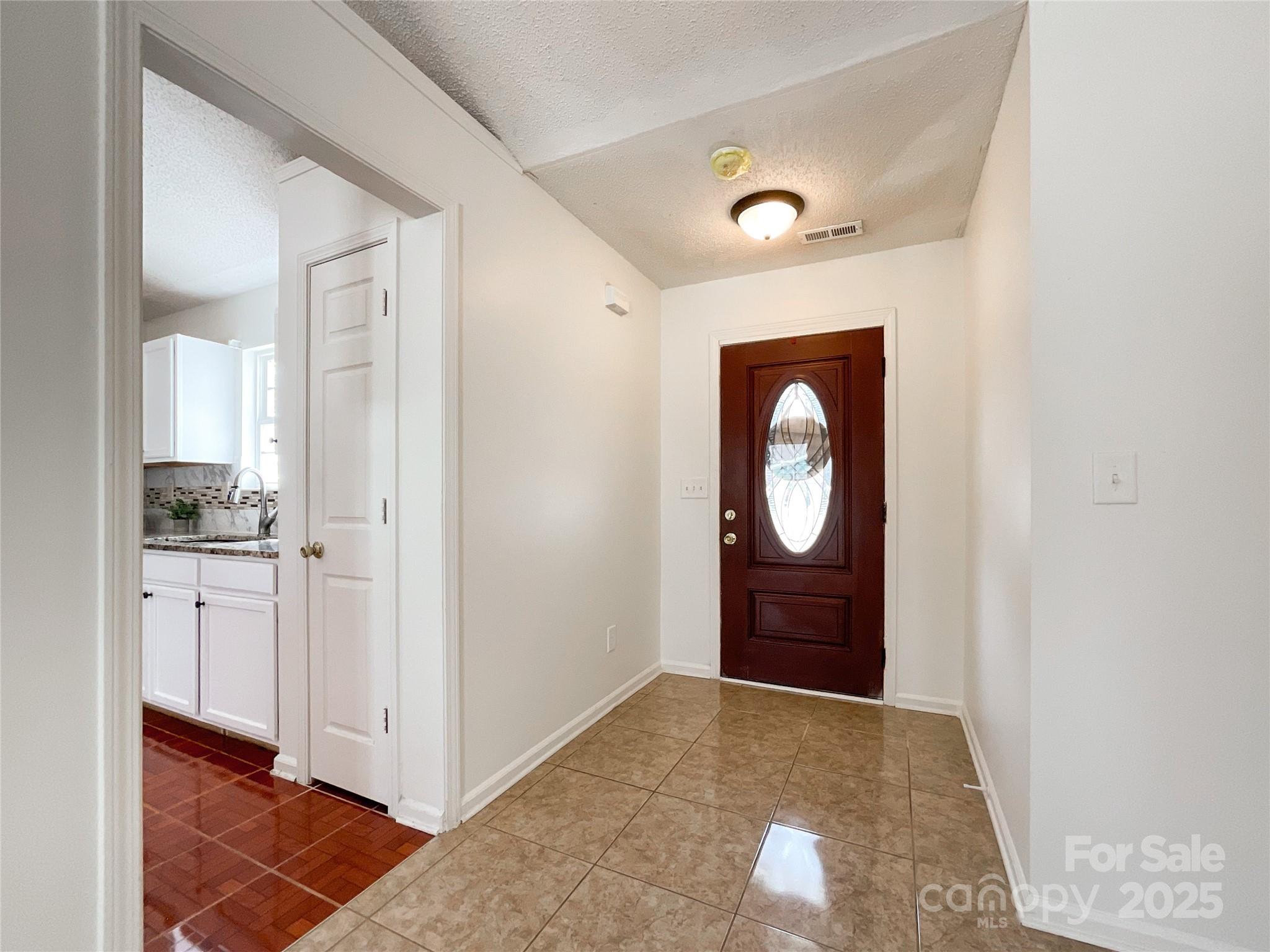 5610 Stone Bluff Court Charlotte, NC 28214 - Photo 3 of 41 a view of an empty room with wooden floor and a window