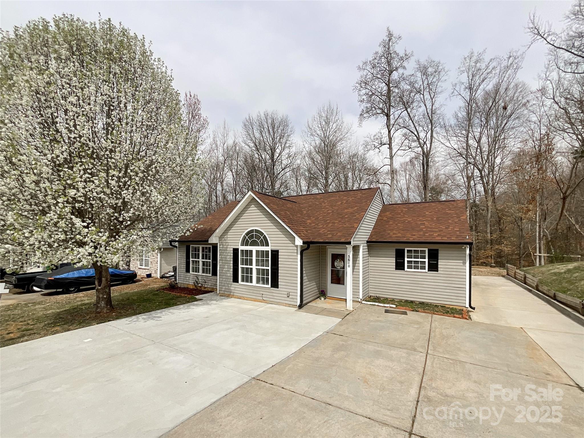 5610 Stone Bluff Court Charlotte, NC 28214 - Photo 32 of 41 a view of a house with a yard and large trees