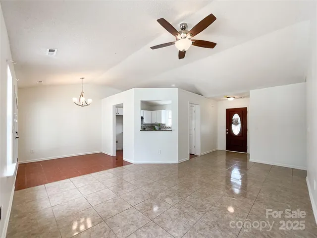a view of a livingroom with a ceiling fan and window