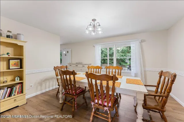 a spacious bedroom with a bed and a chandelier