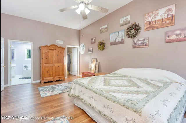 a bedroom with a bed window and a chandelier