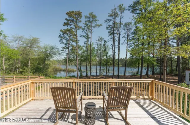 a view of a chair and tables and chairs on the roof deck