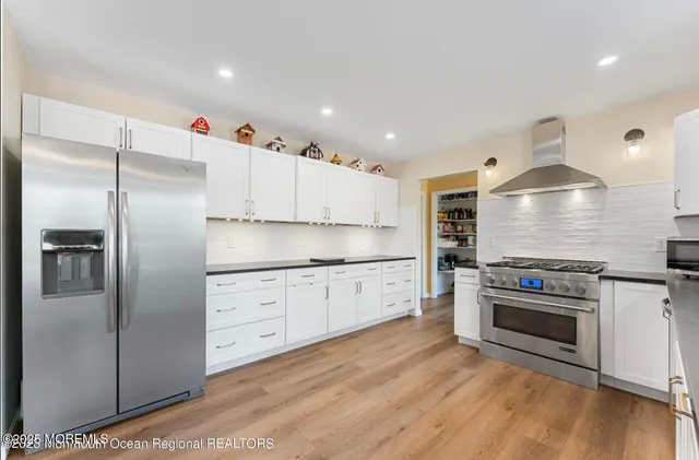 a kitchen with stainless steel appliances a stove and cabinets