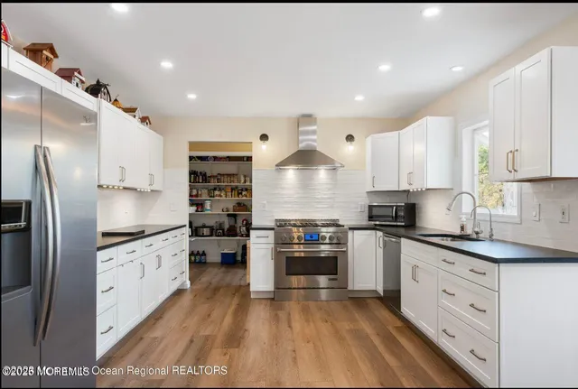 a kitchen with granite countertop a stove and a sink