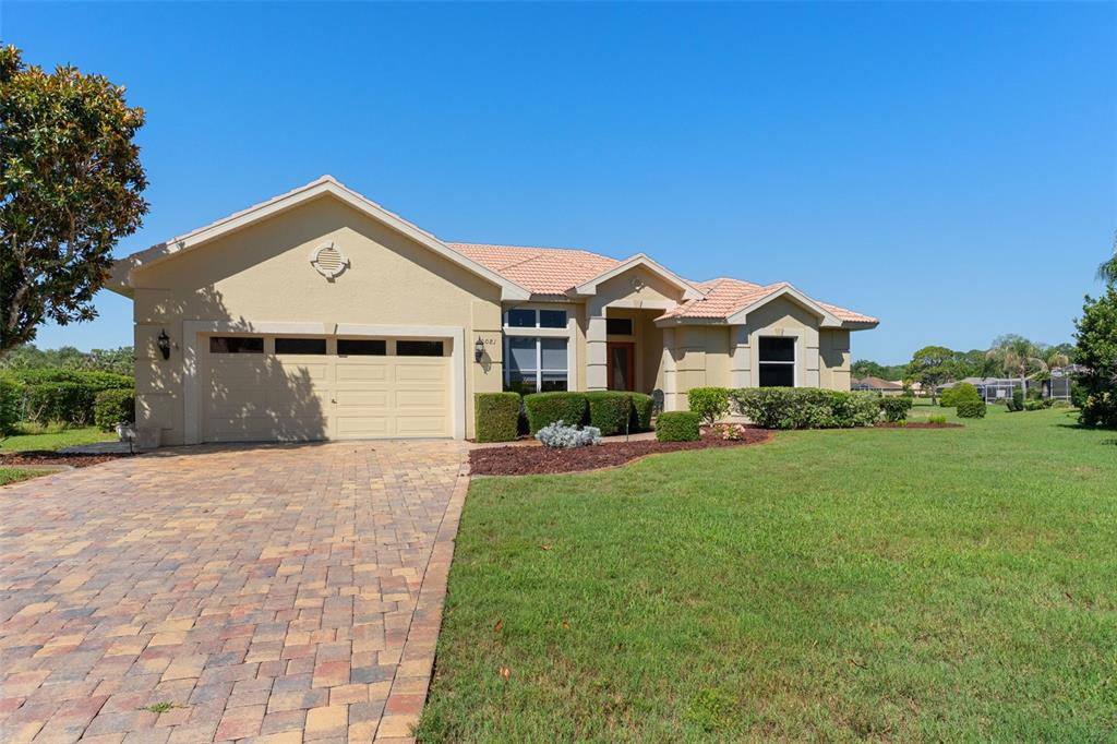 10081 Georgetown Court Weeki Wachee, FL 34613 - Photo 73 of 76 a front view of a house with a garden and yard
