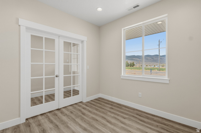 169 West 100 South Joseph, UT 84739 - Photo 7 of 35 Spare room featuring a mountain view, light wood-style flooring, french doors, and recessed lighting