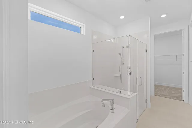 a bathroom with a bathtub and a shower