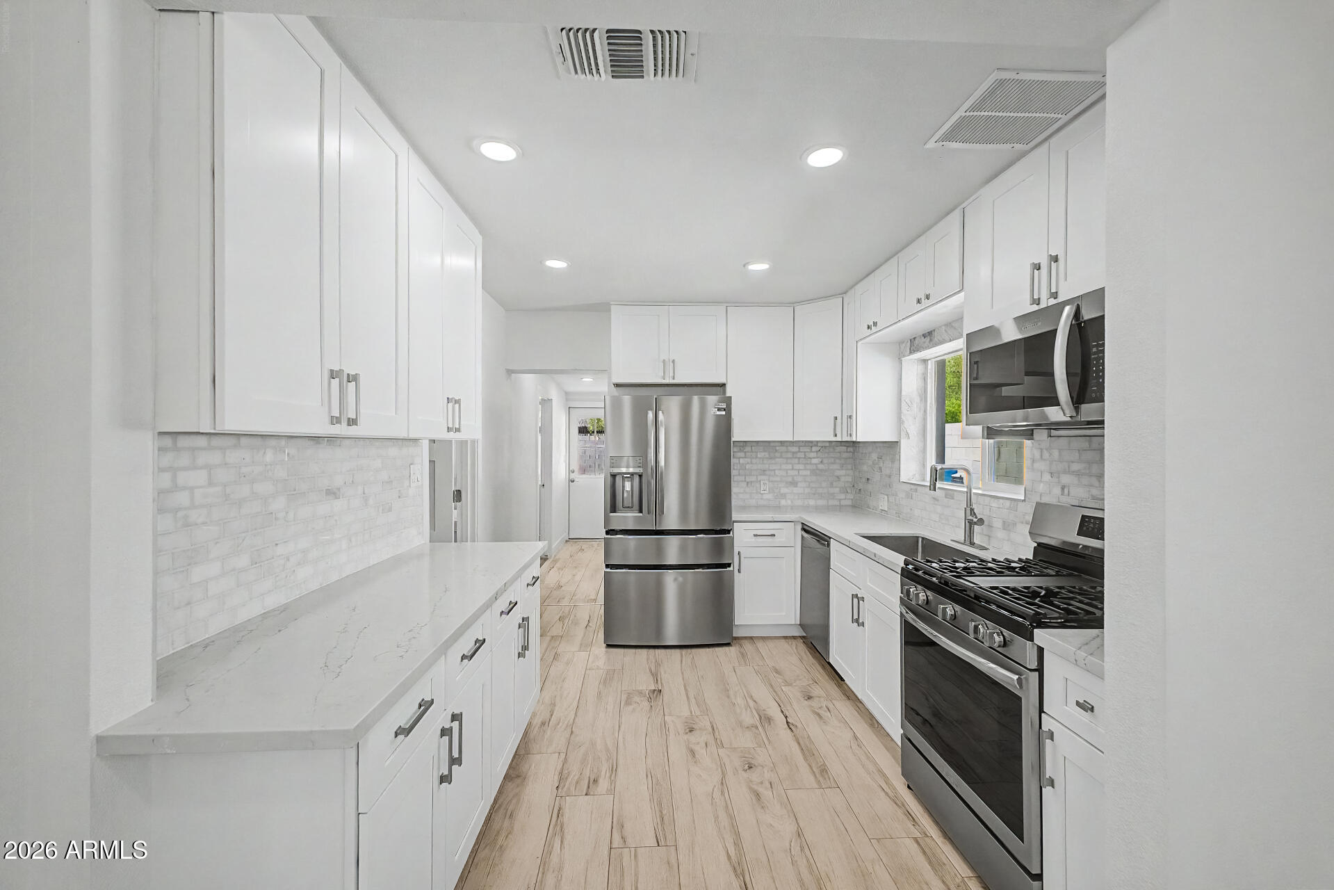 532 East Cheery Lynn Road Phoenix, AZ 85014 - Photo 12 of 37 a kitchen with stainless steel appliances a refrigerator stove and microwave