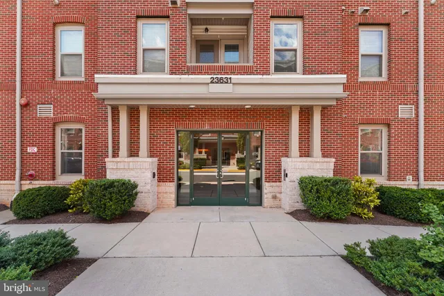 front view of a brick house with a large windows