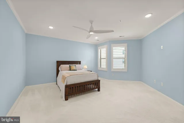 a spacious bedroom with a bed and a window