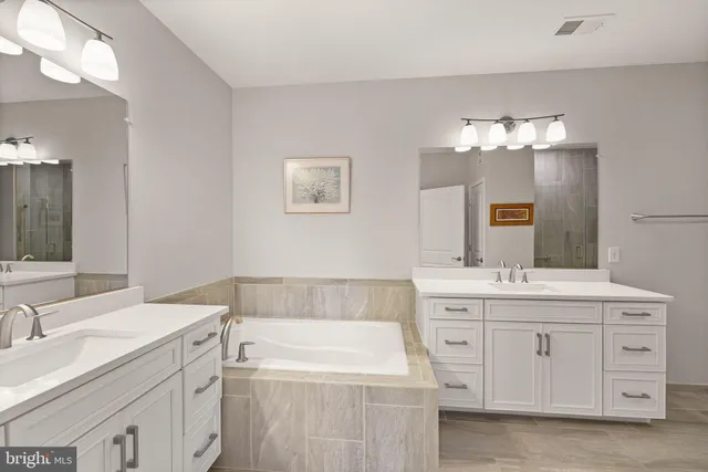 a bathroom with a sink double vanity and a mirror