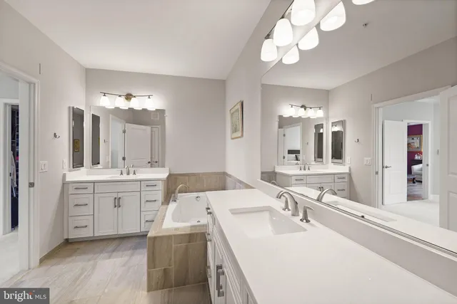 a bathroom with a sink vanity tub and shower