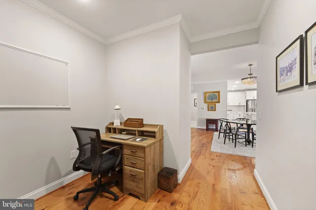 a view of a workspace with furniture and wooden floor