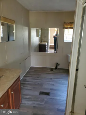 a view of hallway with wooden floor