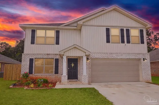 a kitchen with stainless steel appliances granite countertop a stove top oven a refrigerator a sink and dishwasher with wooden floor