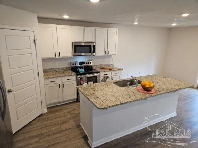 a kitchen with a sink and microwave