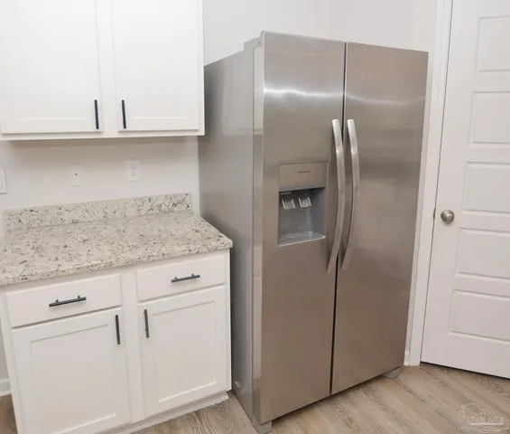 a bathroom with a granite countertop sink toilet a mirror and shower