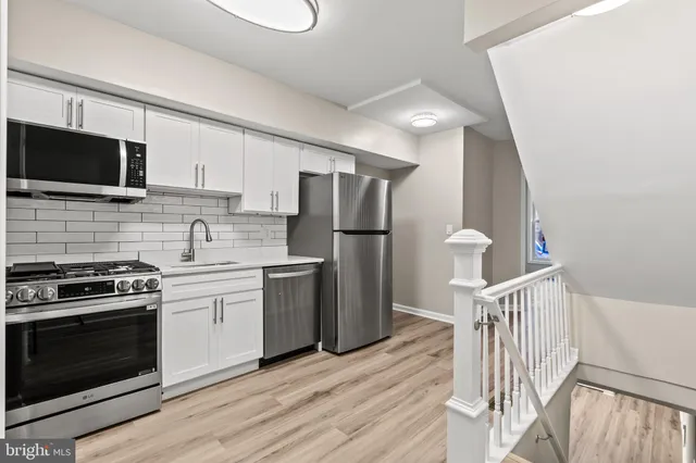 a kitchen with a refrigerator stove and microwave