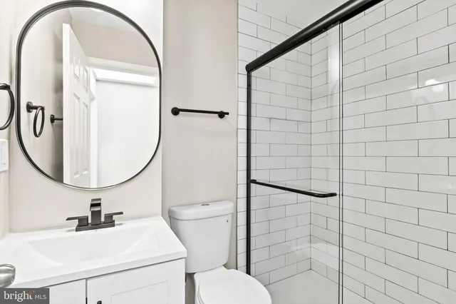 a bathroom with a sink toilet and a mirror
