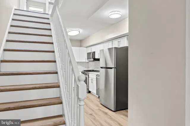 a view of entryway with cabinets and stainless steel appliances