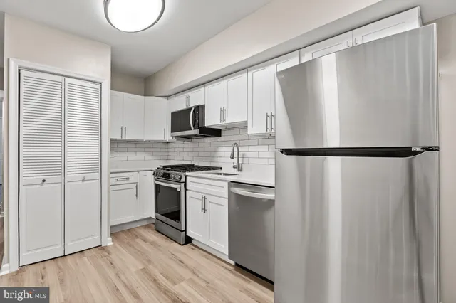 a kitchen with a refrigerator a stove top oven a sink and dishwasher