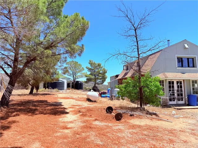 a view of a house with snow on the road
