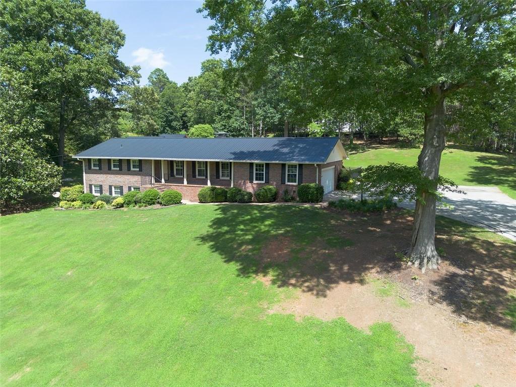 408 Mac Johnson Road Northwest Cartersville, GA 30121 - Photo 3 of 79 a front view of a house with a yard