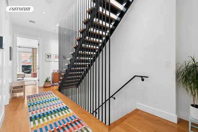 a bathroom with a white bath tub a sink and a white door