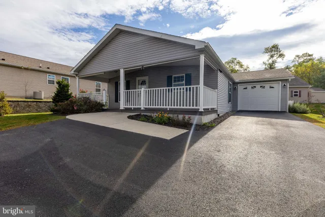 a view of a house with a yard and garage