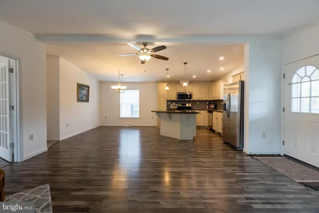 a view of kitchen and hall with wooden floor