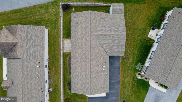 an aerial view of a house with garden space and a lake view