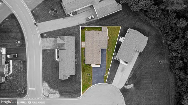 an aerial view of a house with garden space and street view