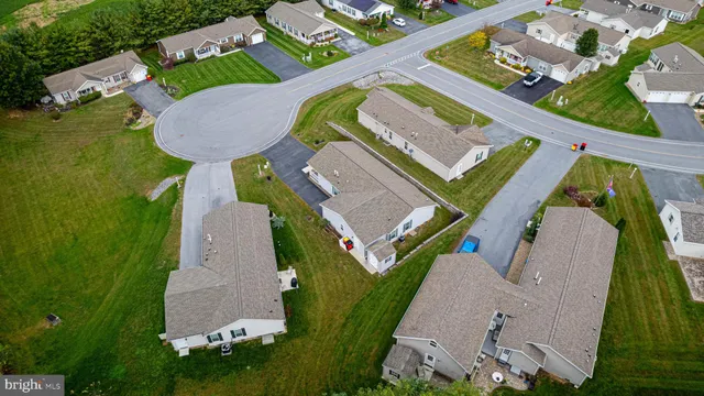 an aerial view of a house with outdoor space pool seating area and yard