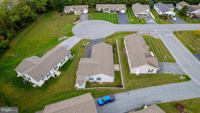 an aerial view of a house with garden space and street view