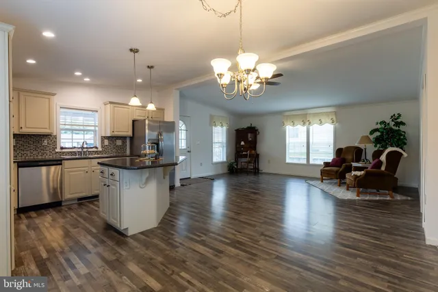 a view of a kitchen and dining room with wooden floor and a kitchen
