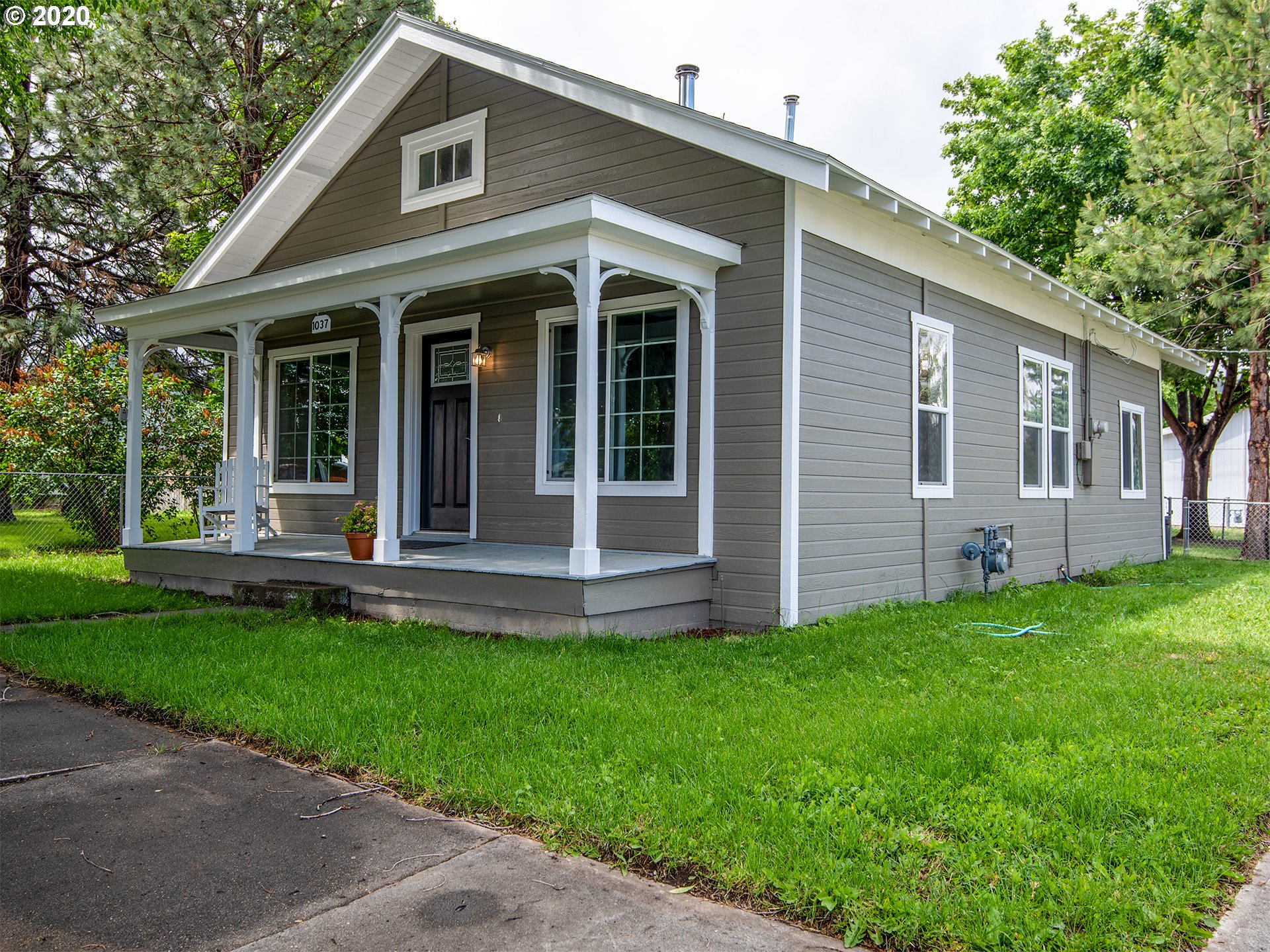 1037 Walnut Street Baker City, OR 97814 - Photo 1 of 14 a view of a house with a yard and a large tree