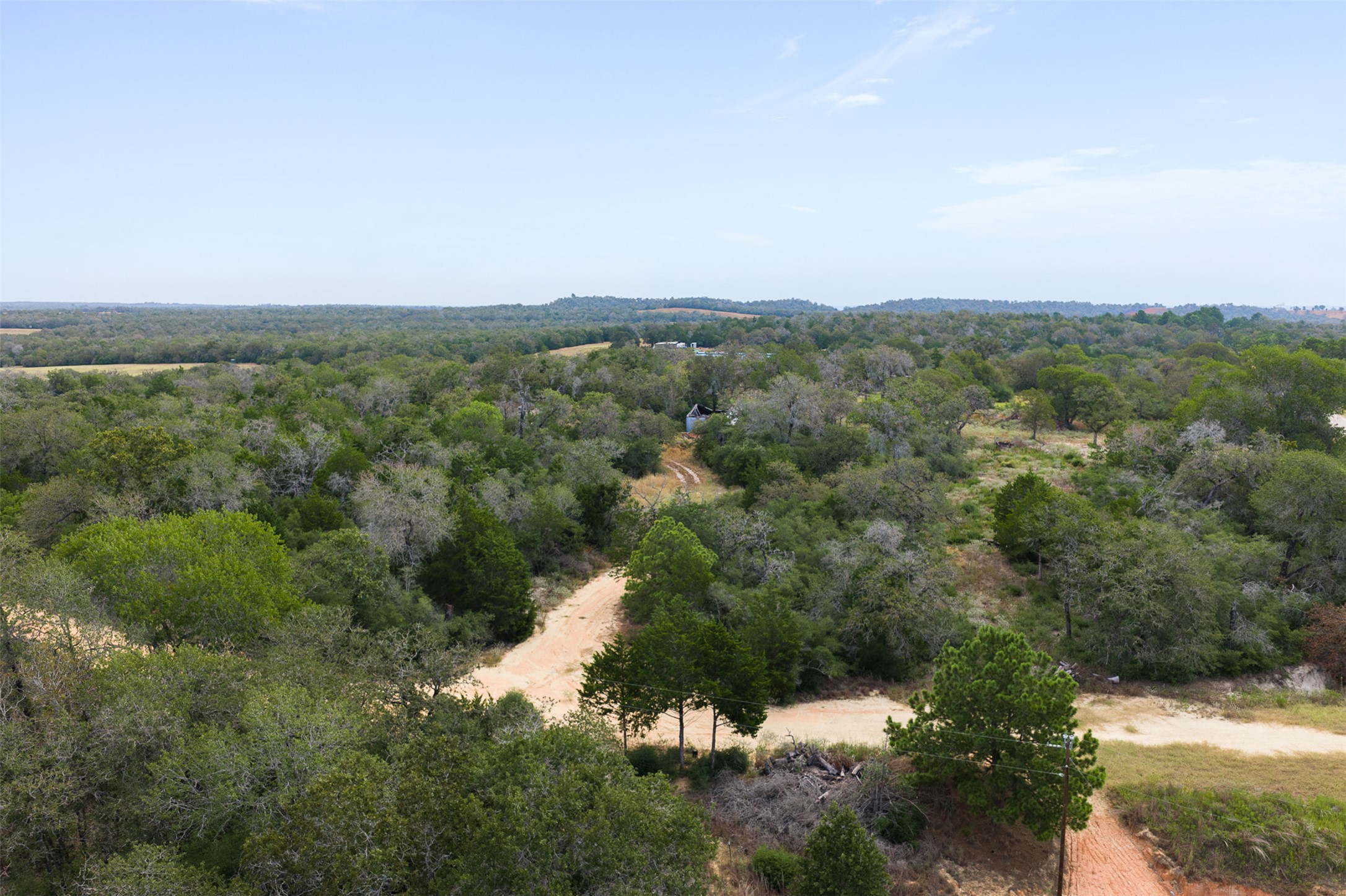 3301 Chuckwagon Road Harwood, TX 78632 - Photo 36 of 36 Mature trees blanket the rolling landscape surrounding winding dirt pathways on this expansive property.