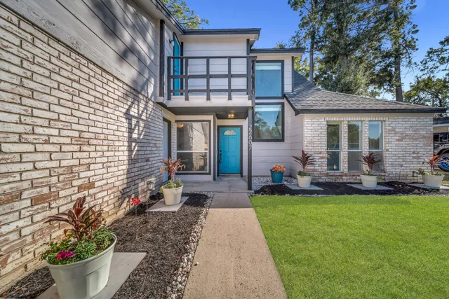 a view of a brick house with potted plants