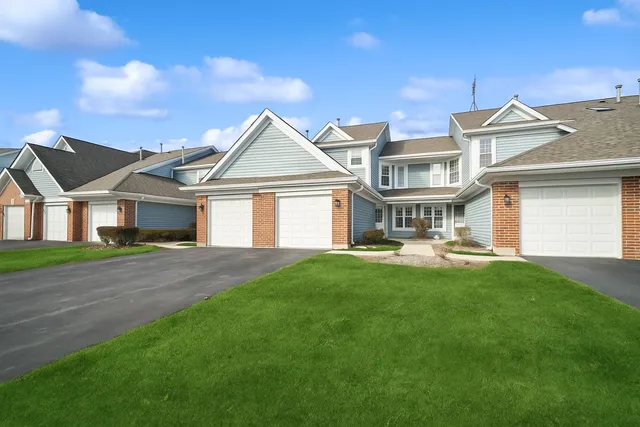 a front view of a house with yard and green space