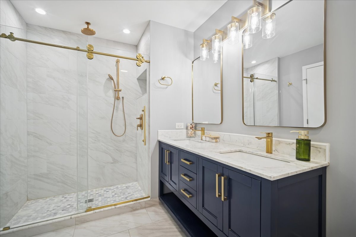 216 Winnsboro Court, Unit A Schaumburg, IL 60193 - Photo 14 of 20 a bathroom with a double vanity sink mirror and shower