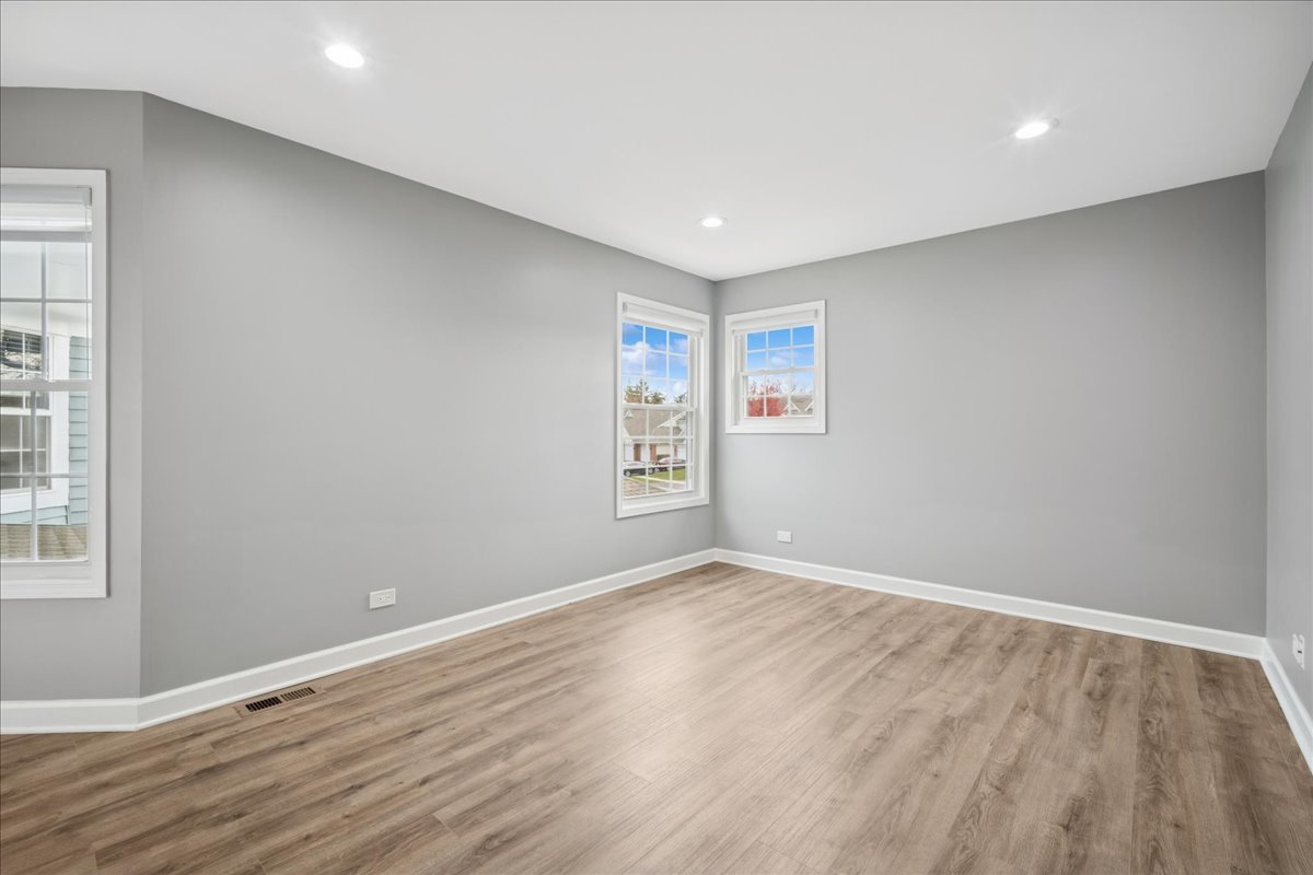 216 Winnsboro Court, Unit A Schaumburg, IL 60193 - Photo 15 of 20 a view of room with window and wooden floor