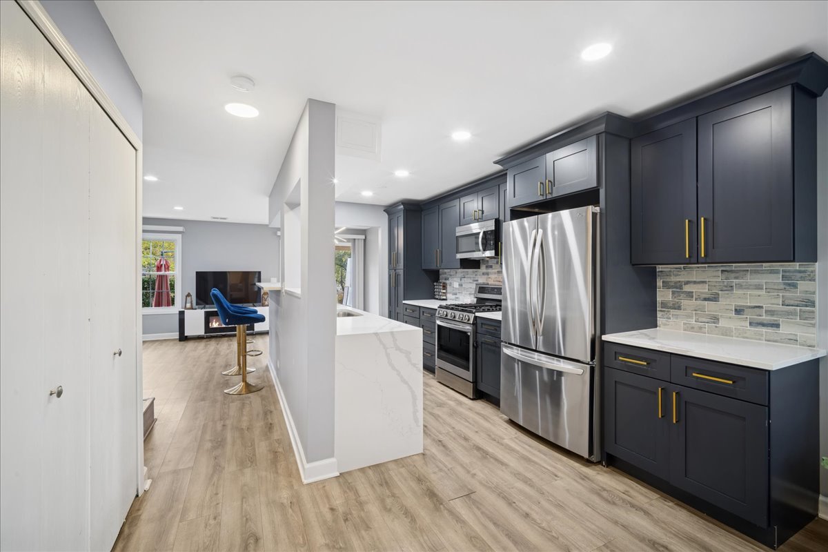 216 Winnsboro Court, Unit A Schaumburg, IL 60193 - Photo 3 of 20 a kitchen with refrigerator a sink and wooden floor
