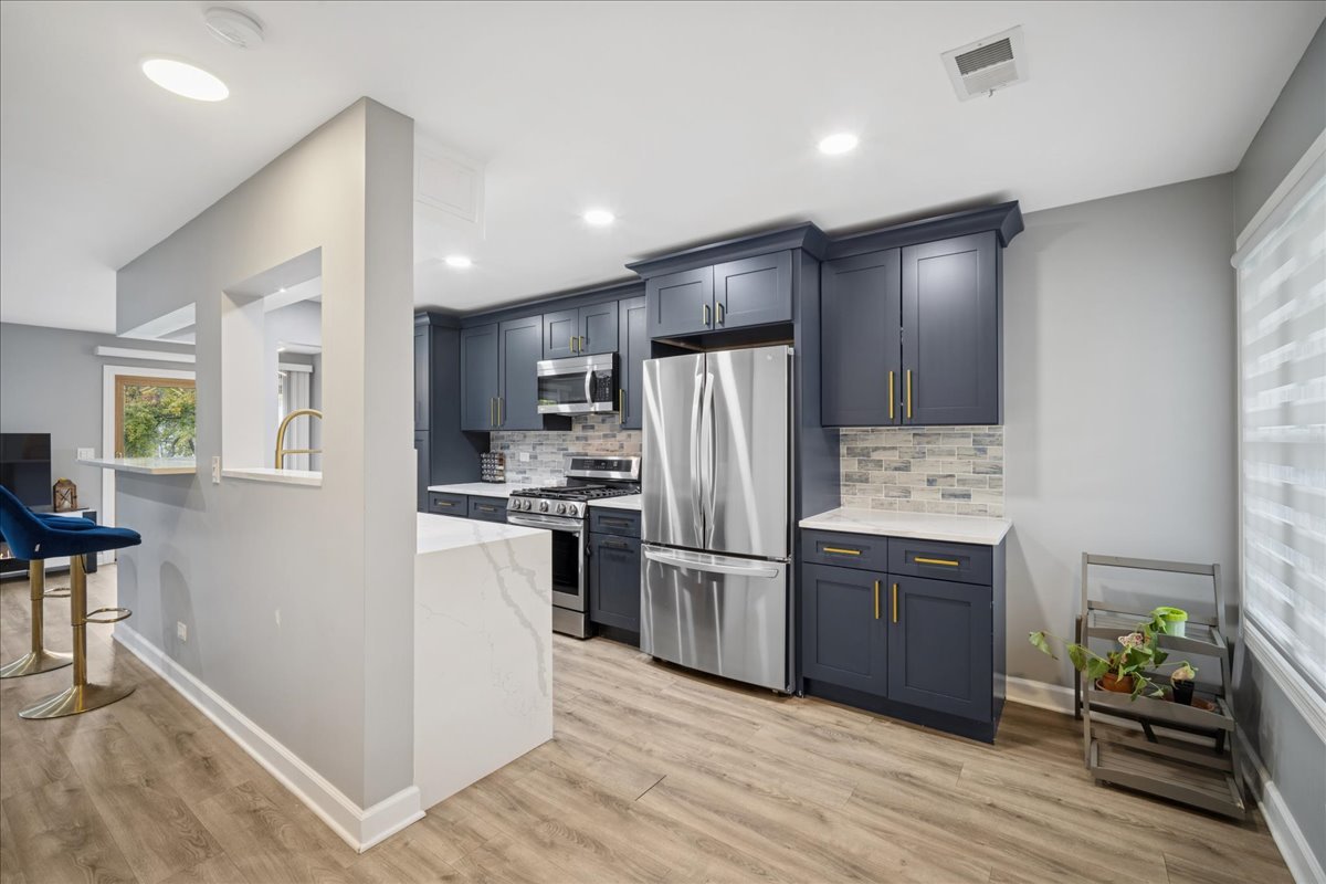 216 Winnsboro Court, Unit A Schaumburg, IL 60193 - Photo 4 of 20 a kitchen with a refrigerator and a stove top oven