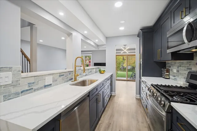 a kitchen with a sink stove top oven and cabinets