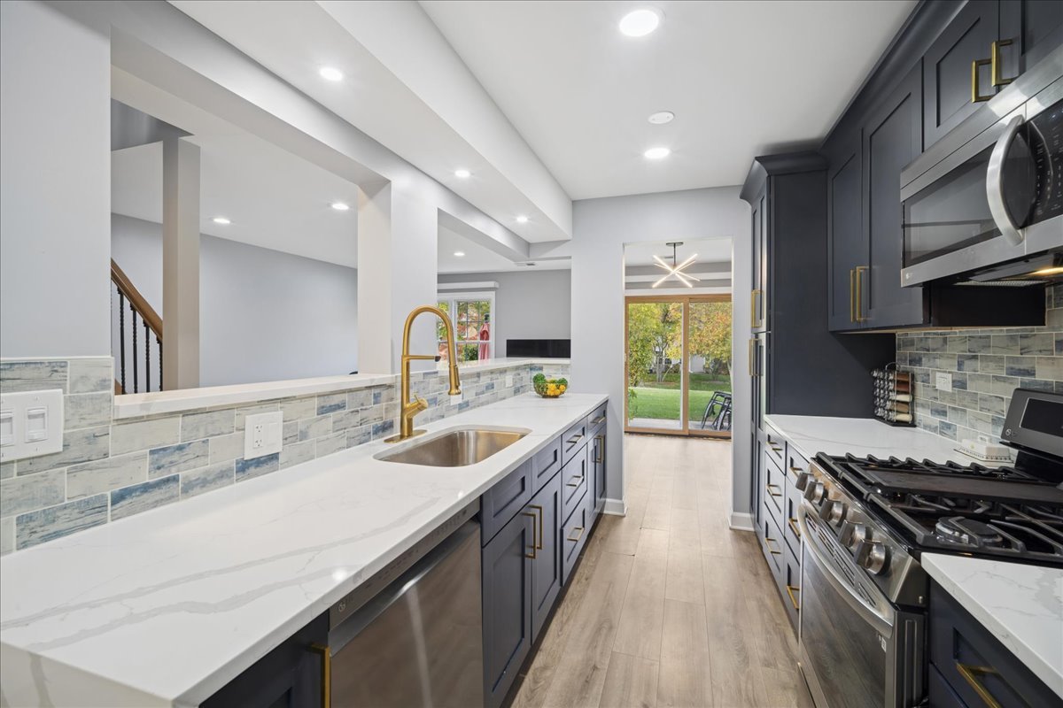 216 Winnsboro Court, Unit A Schaumburg, IL 60193 - Photo 5 of 20 a kitchen with a sink stove top oven and cabinets