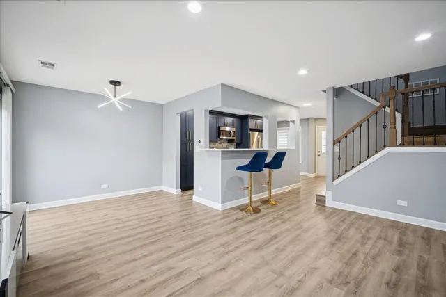 a view of kitchen with sink and refrigerator