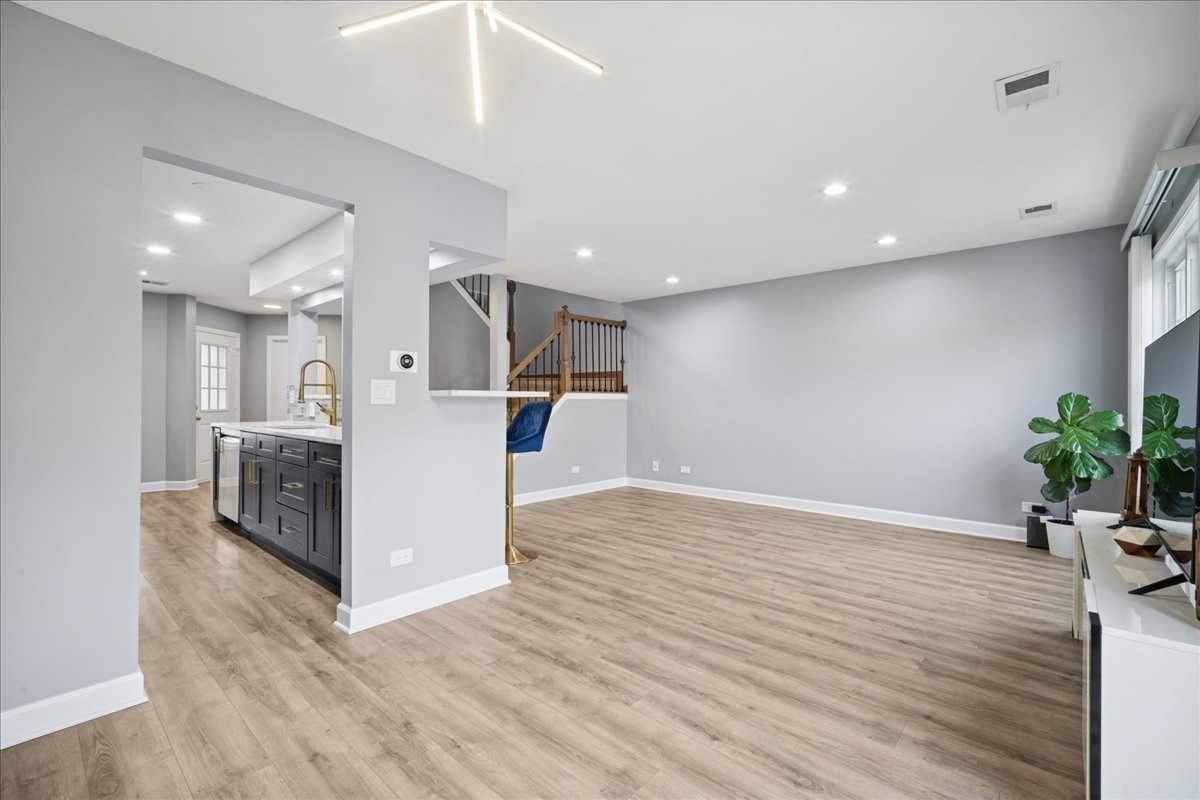 216 Winnsboro Court, Unit A Schaumburg, IL 60193 - Photo 9 of 20 a view of a living room a kitchen and a sink
