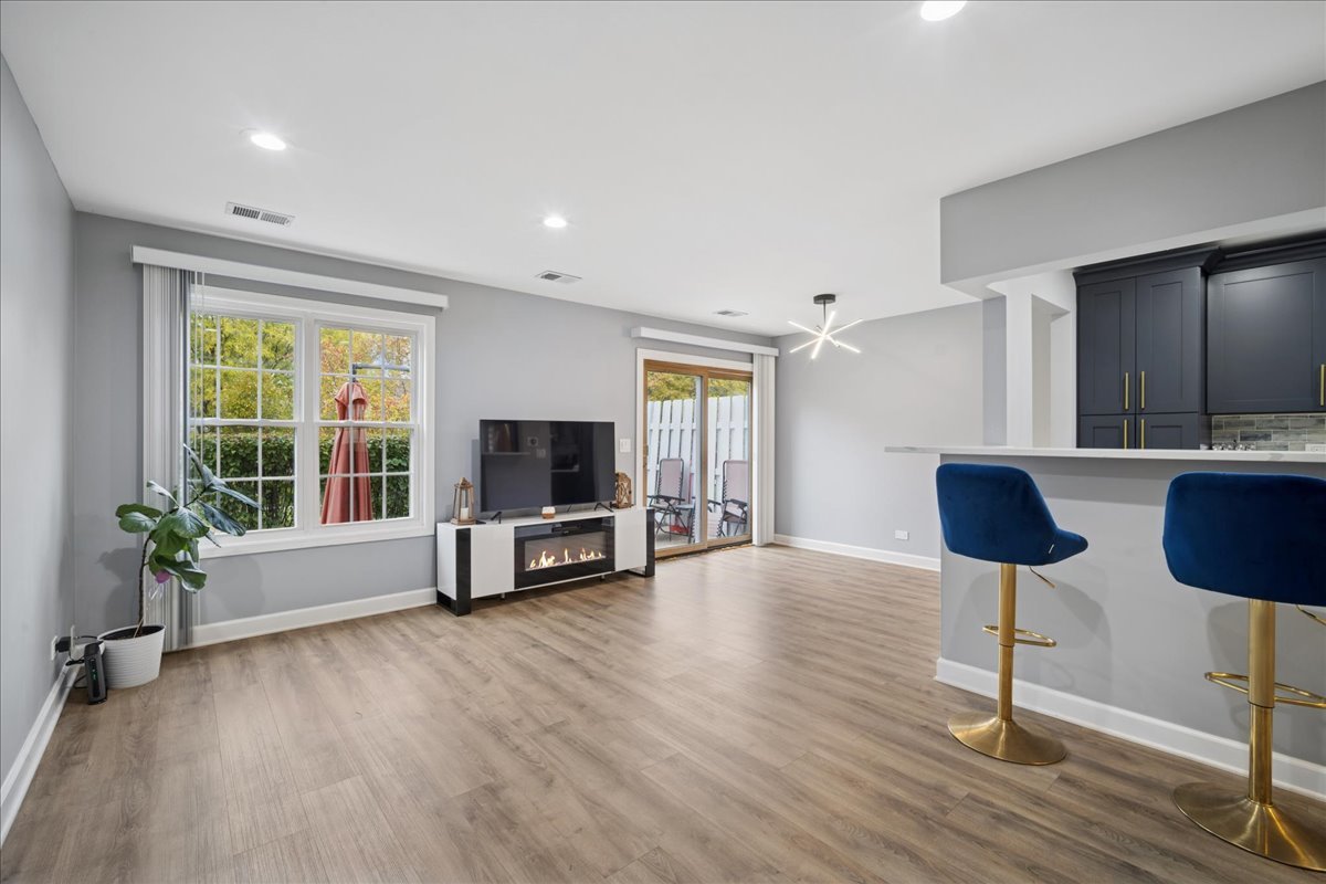 216 Winnsboro Court, Unit A Schaumburg, IL 60193 - Photo 10 of 20 a living room with furniture and a flat screen tv