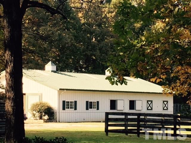 2730 Little River Church Road Hurdle Mills, NC 27541 - Photo 11 of 25 a view of a white house with a big yard and large tree